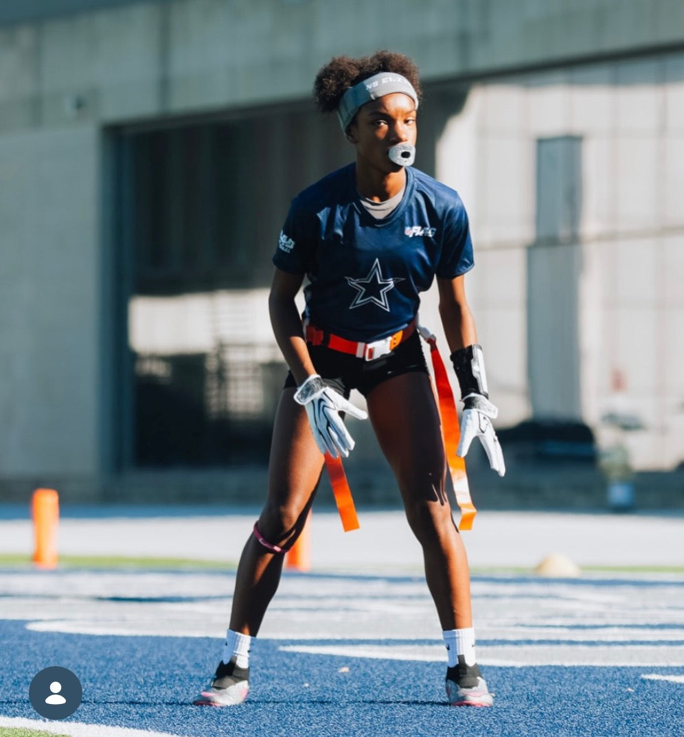 Youth girl wearing the black youth playmaker flag football wrist coach during a game
