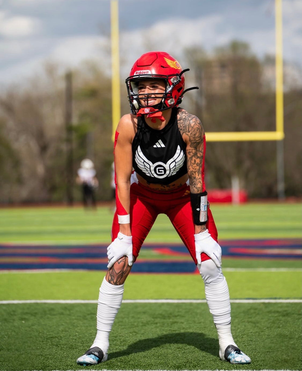 female tackle football athlete wide receiver wearing the black playbook wristband