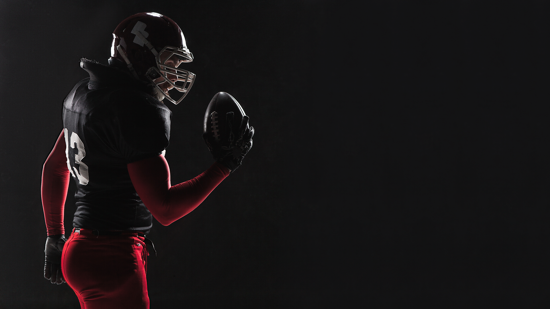 American Football Player Posing with Ball