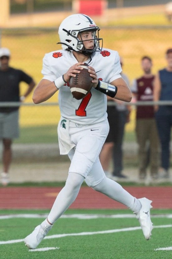 high school football quarterback wearing the black adult playbook wrist coach