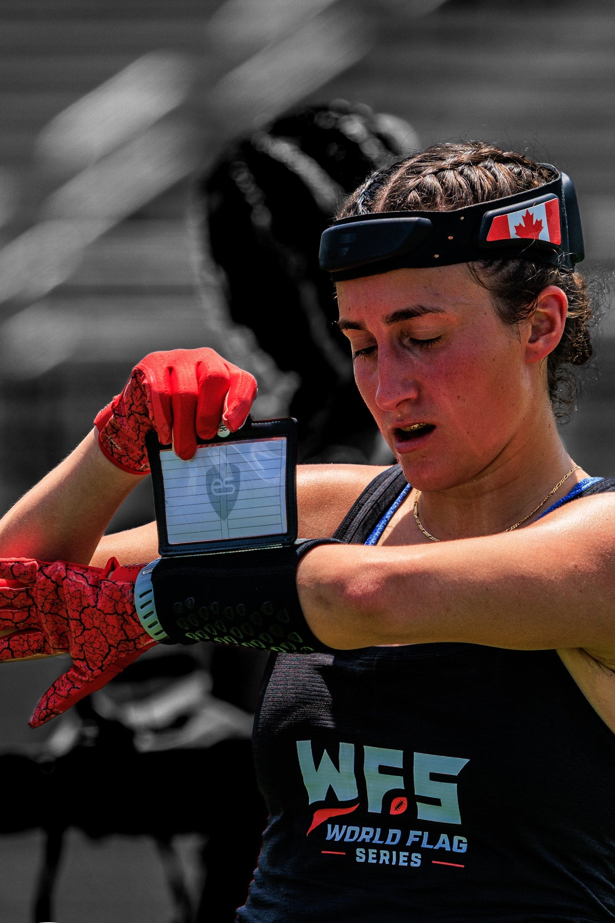 female athlete wearing a black playbook wristband for flag football
