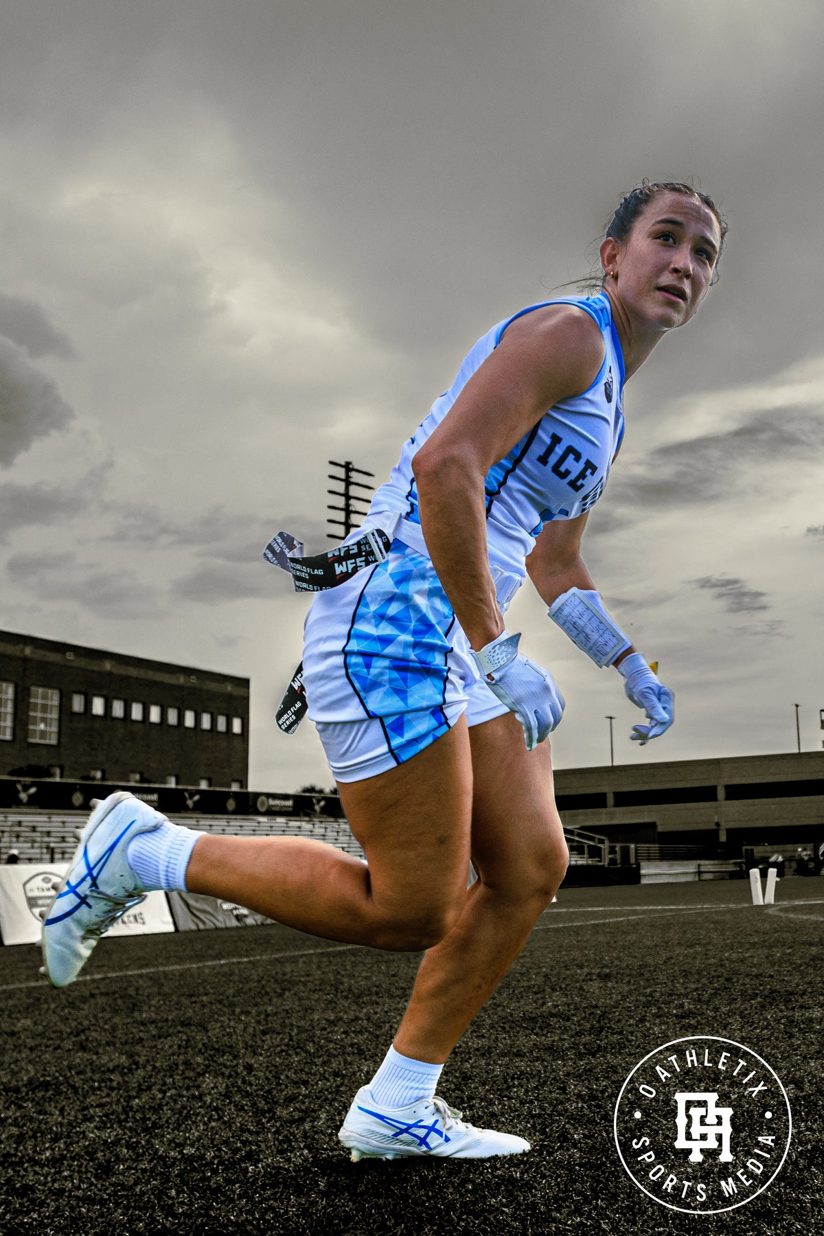 Female flag football player wearing the Playmaker Female Fit Wrist Coach playbook with windows