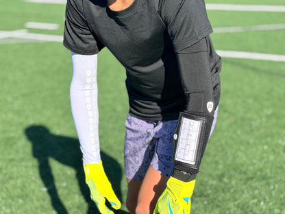 Youth football player getting ready to run a route in the white youth medium compression arm sleeve with grips