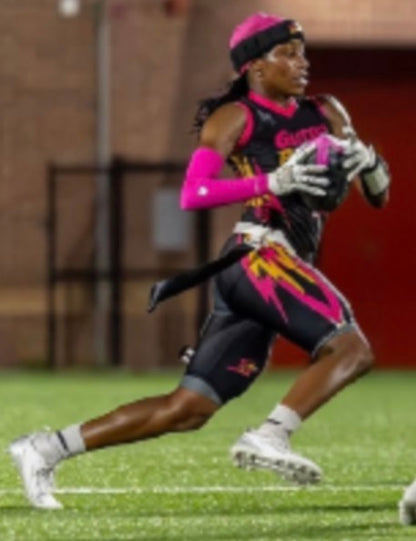 Professional womens flag football player wearing a pink compression arm sleeve running a route in a flag football game