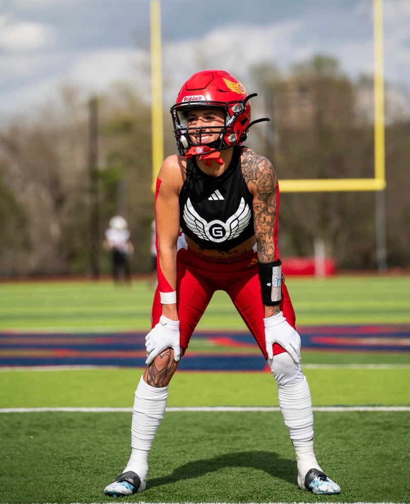 female tackle football athlete wide receiver wearing the black playbook wristband