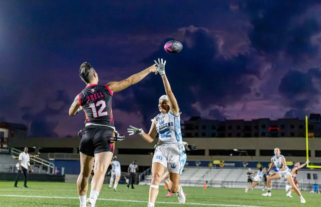 athletes in black football playbook and white football playbook made for female athletes playing flag football